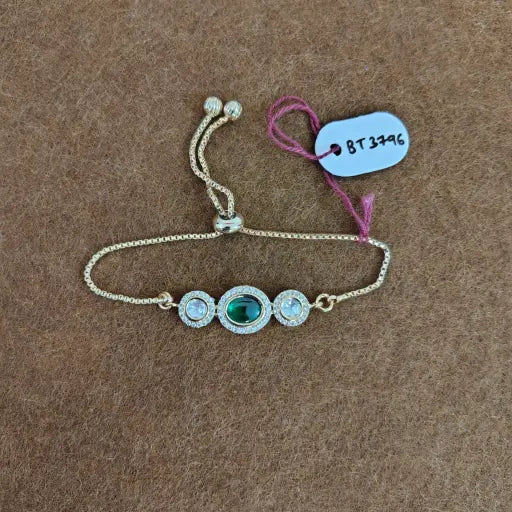 Luxury gold-plated kundan bracelet with emerald center stone, adjustable fit, traditional Indian jewelry