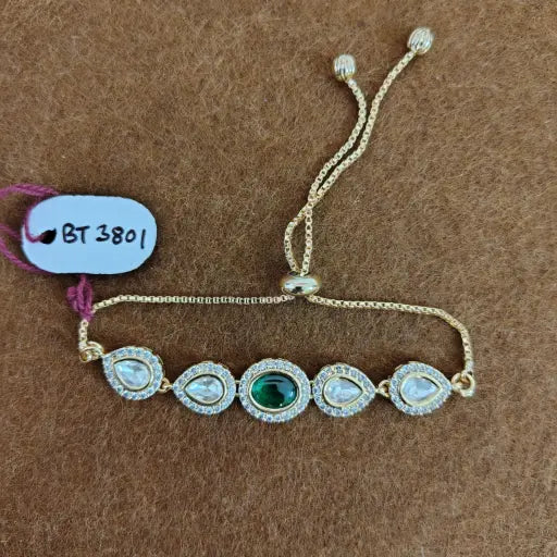 Teardrop kundan bracelet with green enamel accents, elegant jewelry for haldi and roka