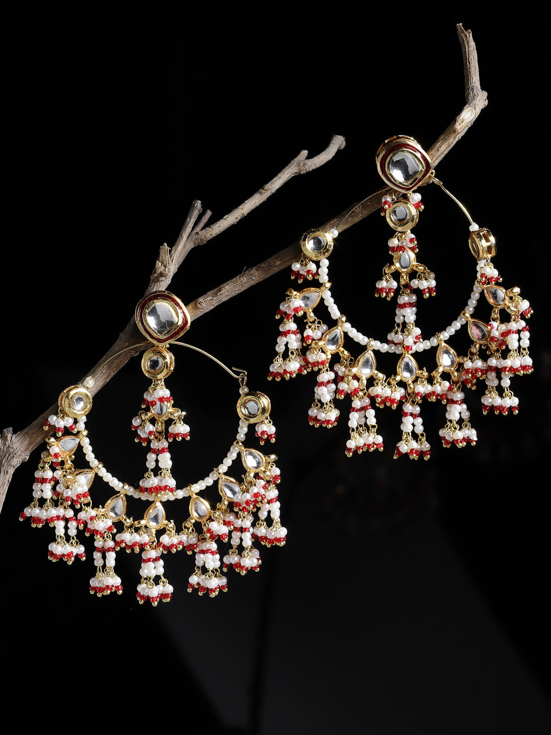 AIVY LUXE currant pink ethnic earrings with intricate beadwork and gold accents hanging on a branch