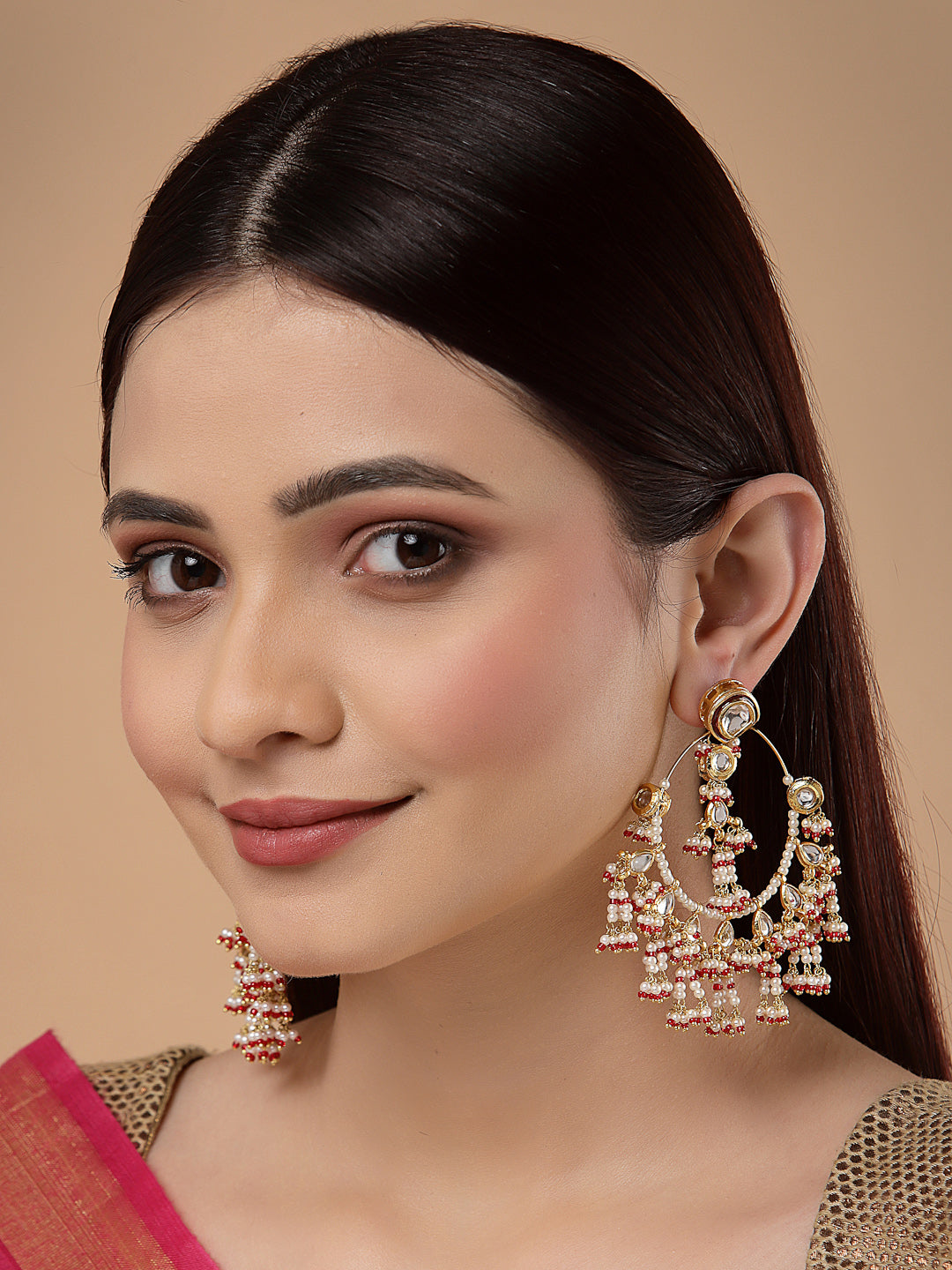 AIVY LUXE currant pink ethnic earrings worn by a woman with long dark hair and traditional attire