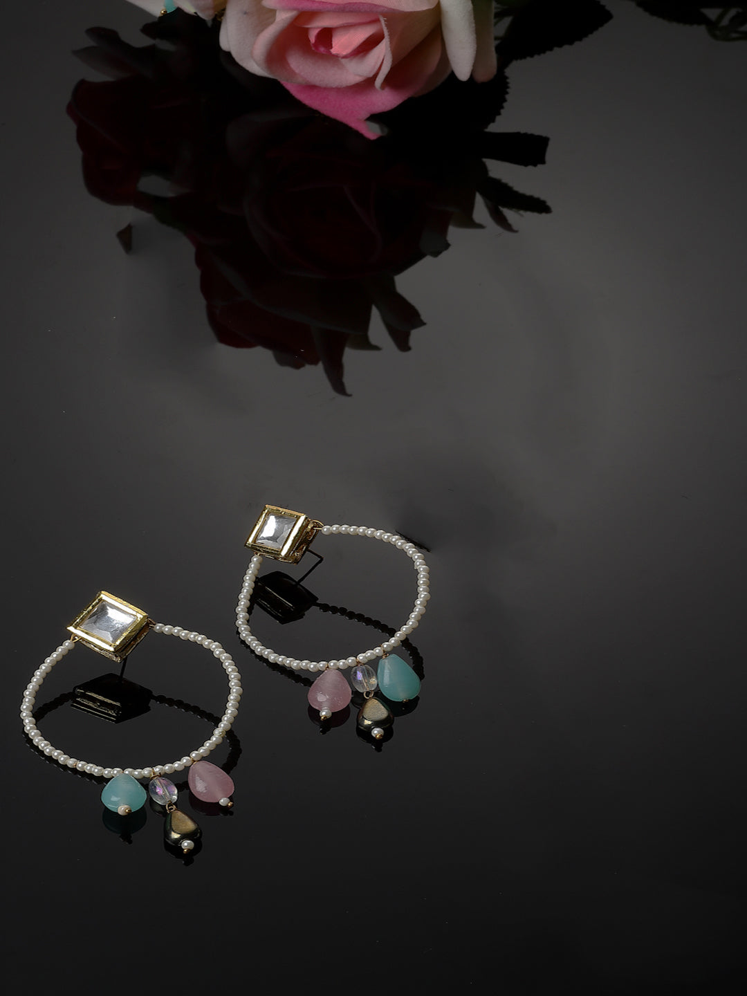 AIVY LUXE designer crescent moon earrings with pink and blue gemstone charms on black background