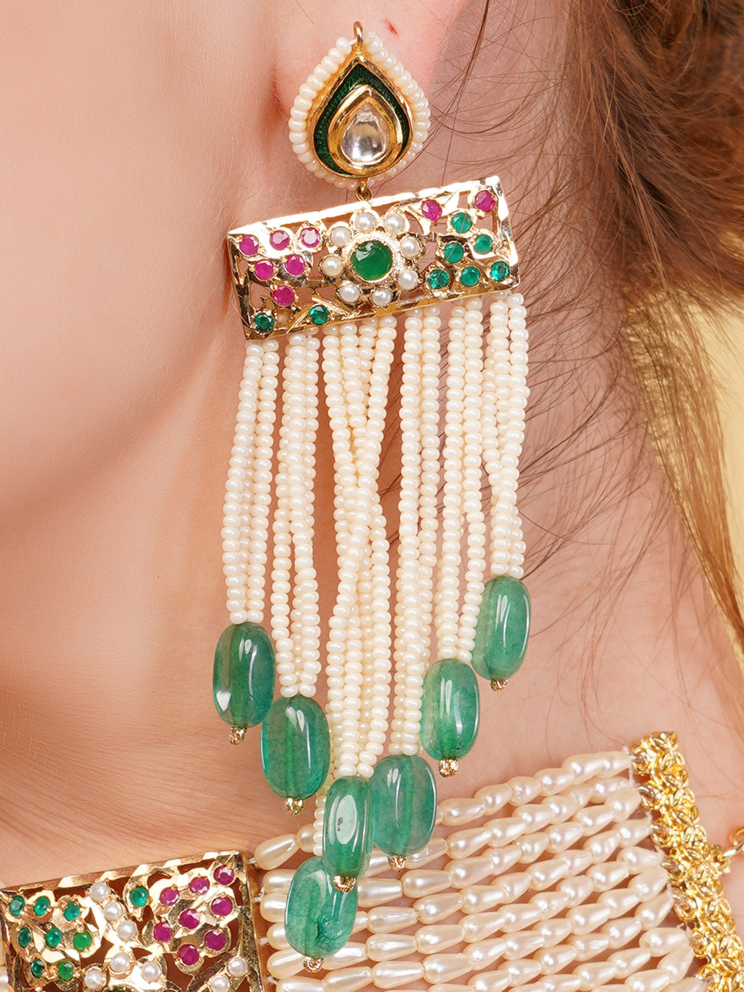 AIVY LUXE ethnic bridal drop earrings with green stones and pearl bead tassels on ear