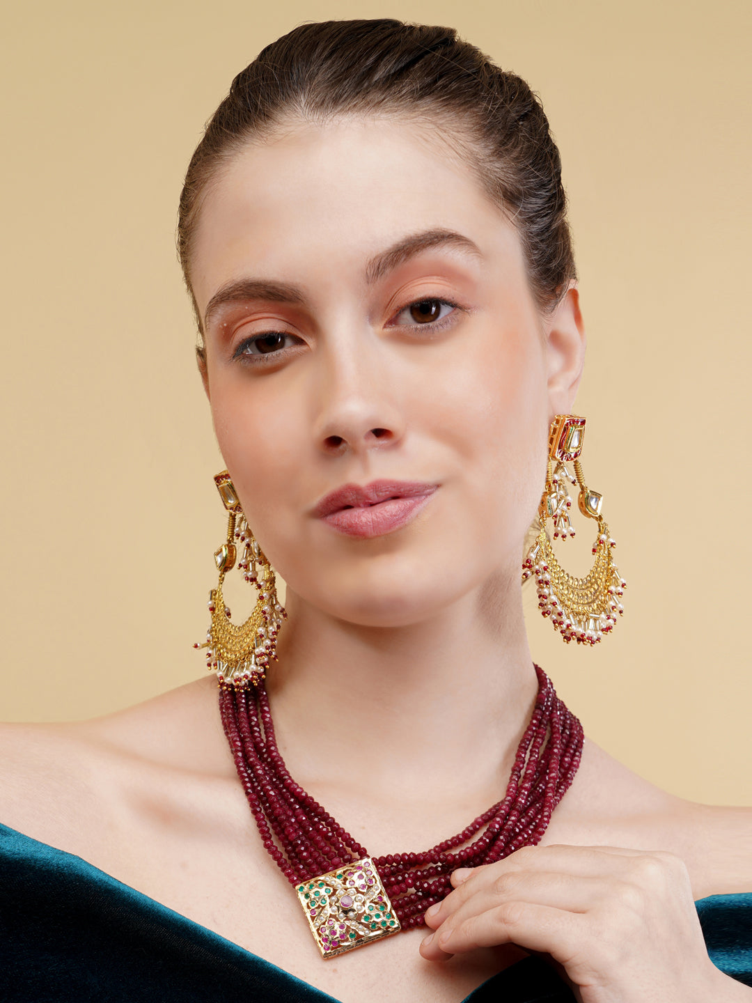 AIVY LUXE luxury beaded jewelry necklace with deep red beads and a detailed multicolor pendant worn by a model