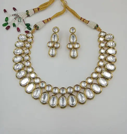 AIVY LUXE luxury bridal jewelry for women featuring a gold and white stone necklace with matching earrings