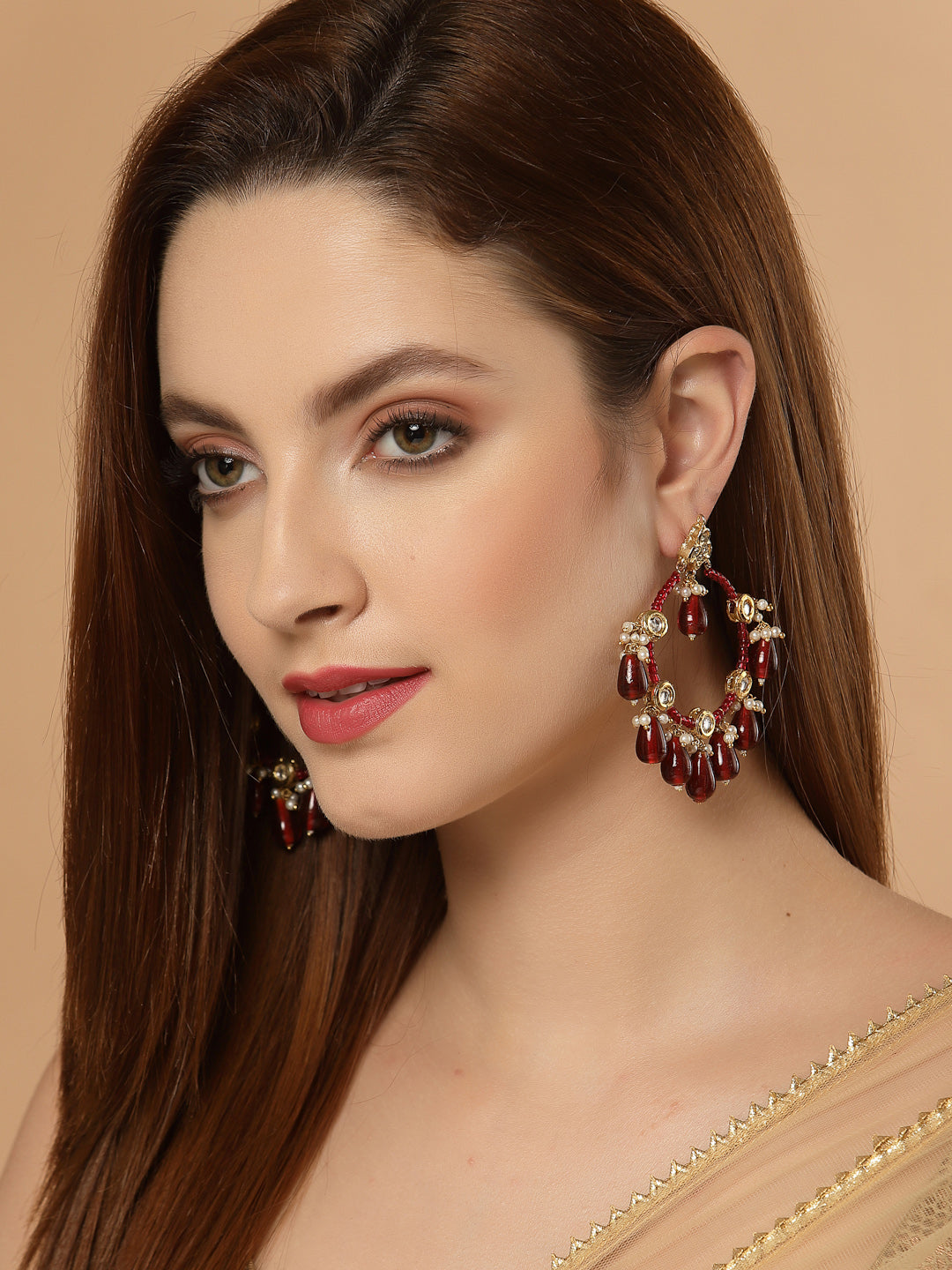 AIVY LUXE red stone statement earrings worn by a woman with long brown hair and natural makeup