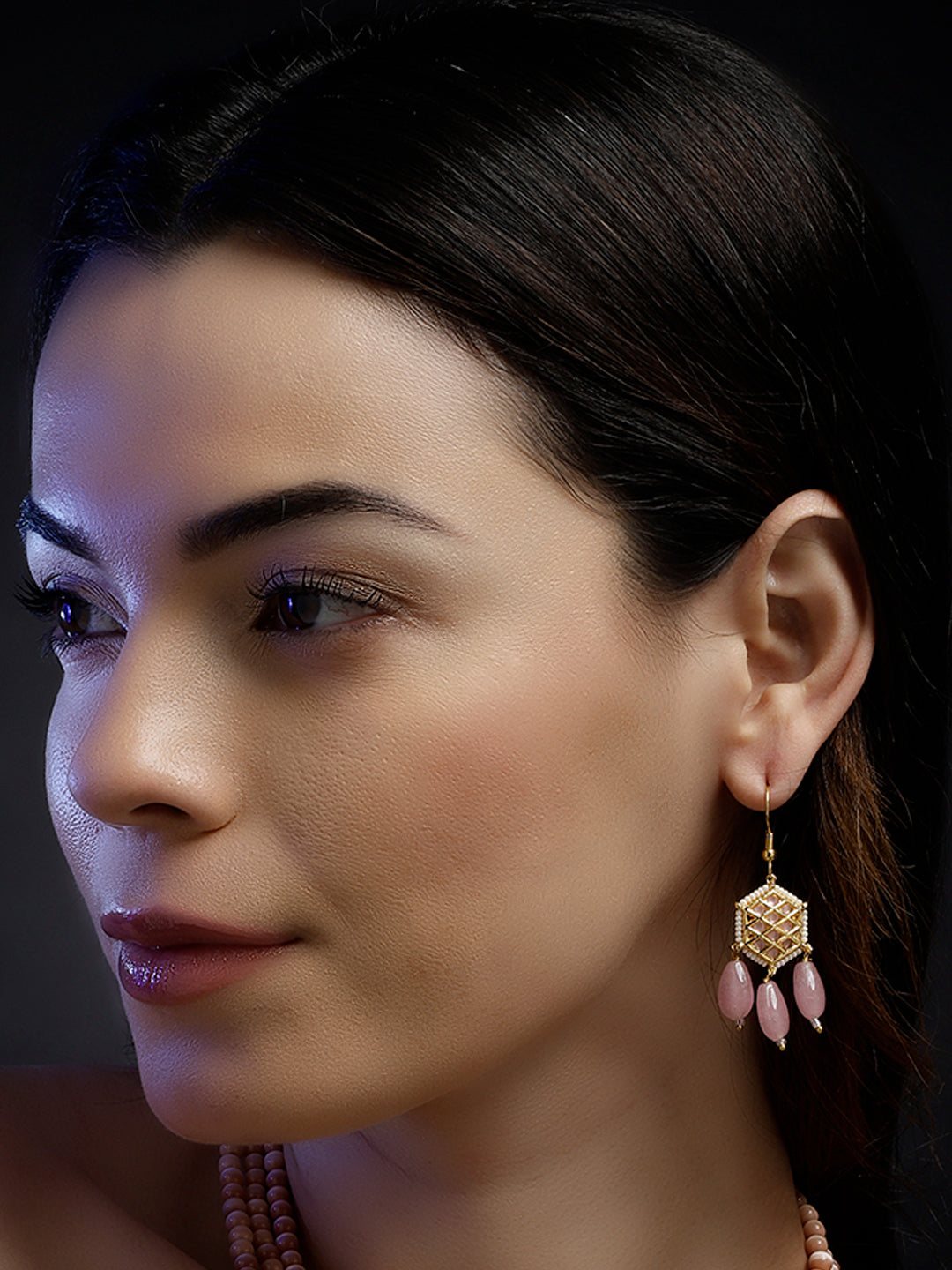AIVY LUXE earring with pink stones and gold detailing showcasing rosy charm fusion jewelry on a woman