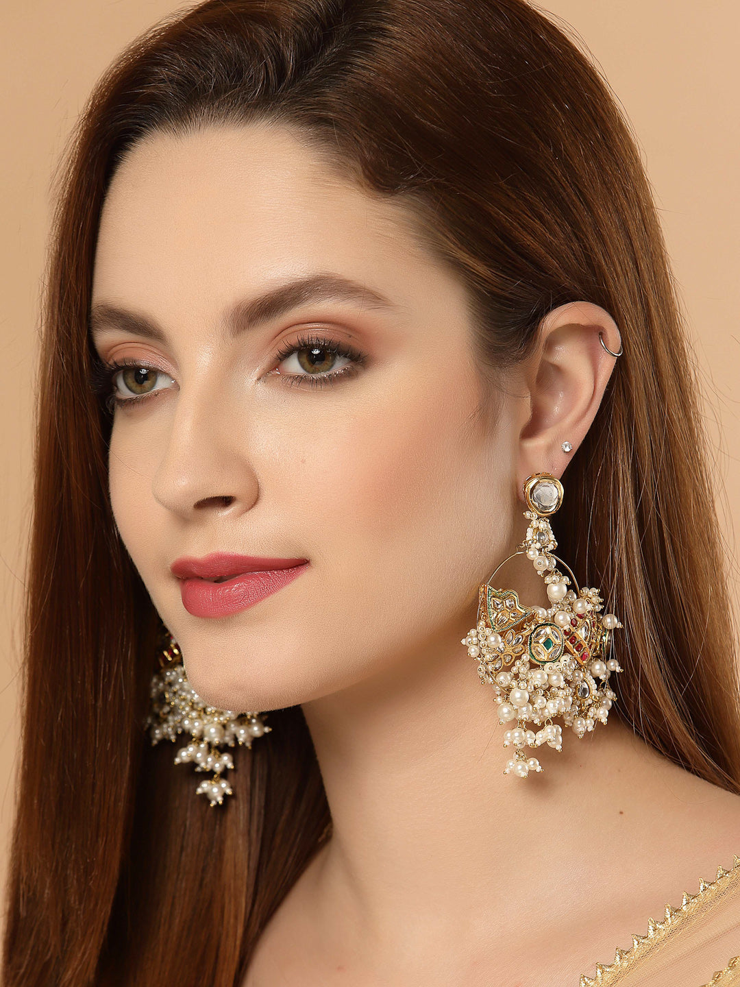 AIVY LUXE sage green chandelier earrings worn by woman with intricate pearl and gem design