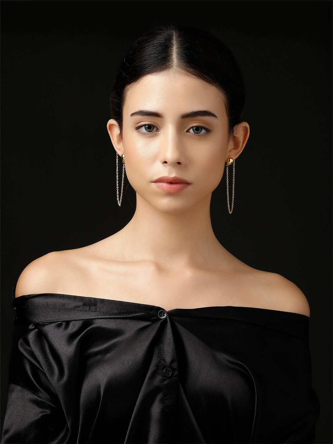 AIVY LUXE Shamsi Glow Drop Earring worn by woman with black off-shoulder satin top against black background