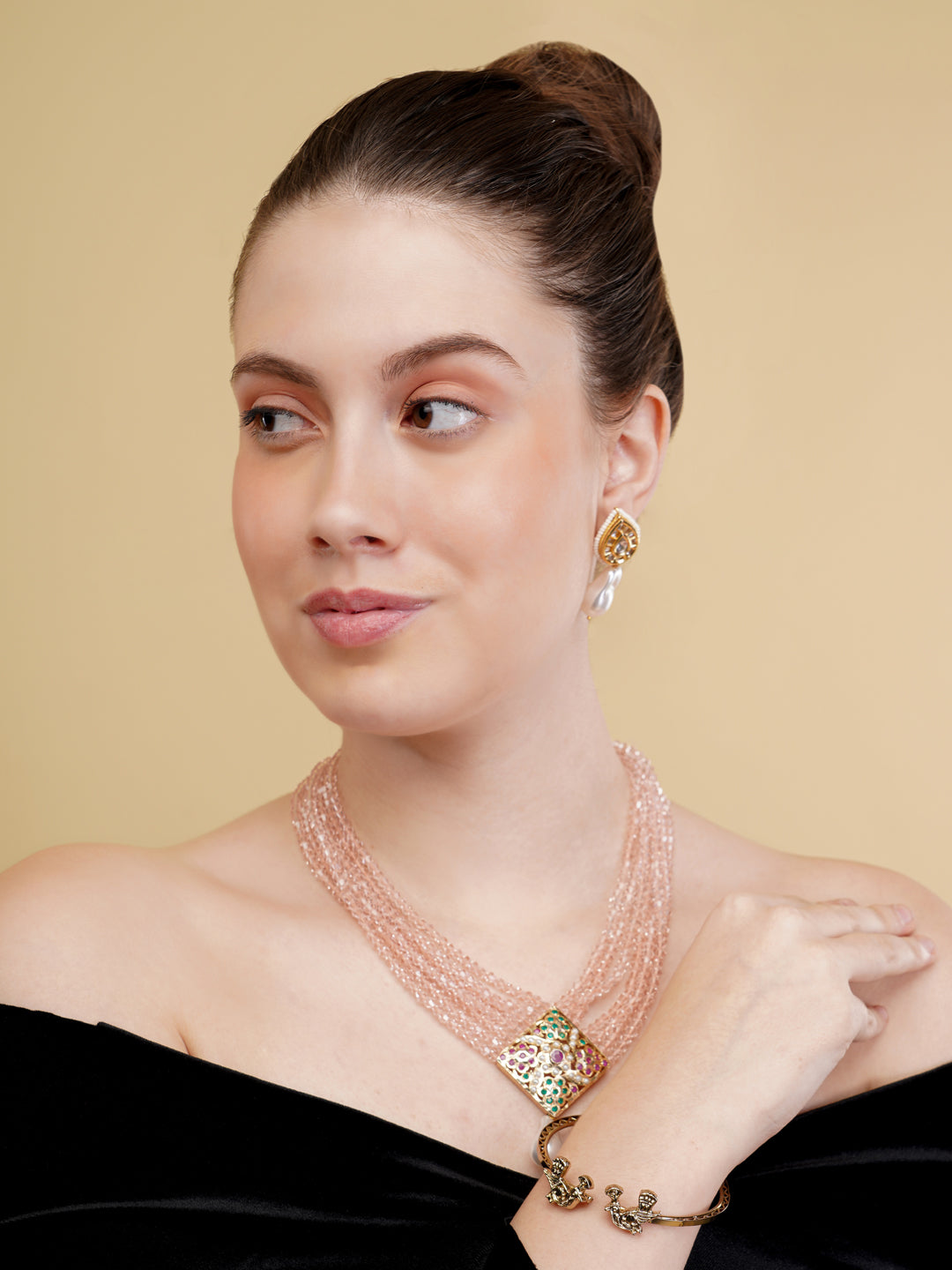 AIVY LUXE statement pearl necklace with multiple strands worn by a woman in a black off-shoulder top