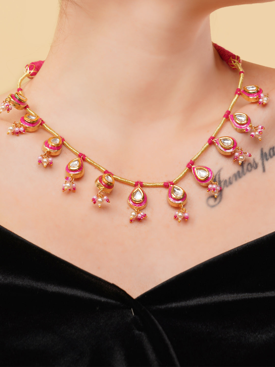 AIVY LUXE statement pink gemstone necklace with gold accents worn on model's neck