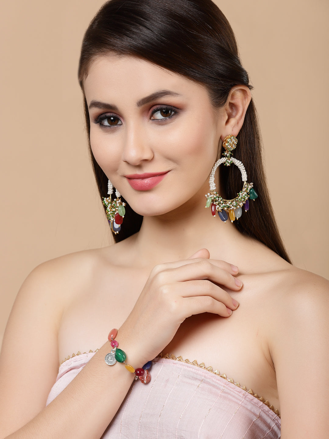 AIVY LUXE teal chand bala earrings worn by a woman with a matching colorful bracelet