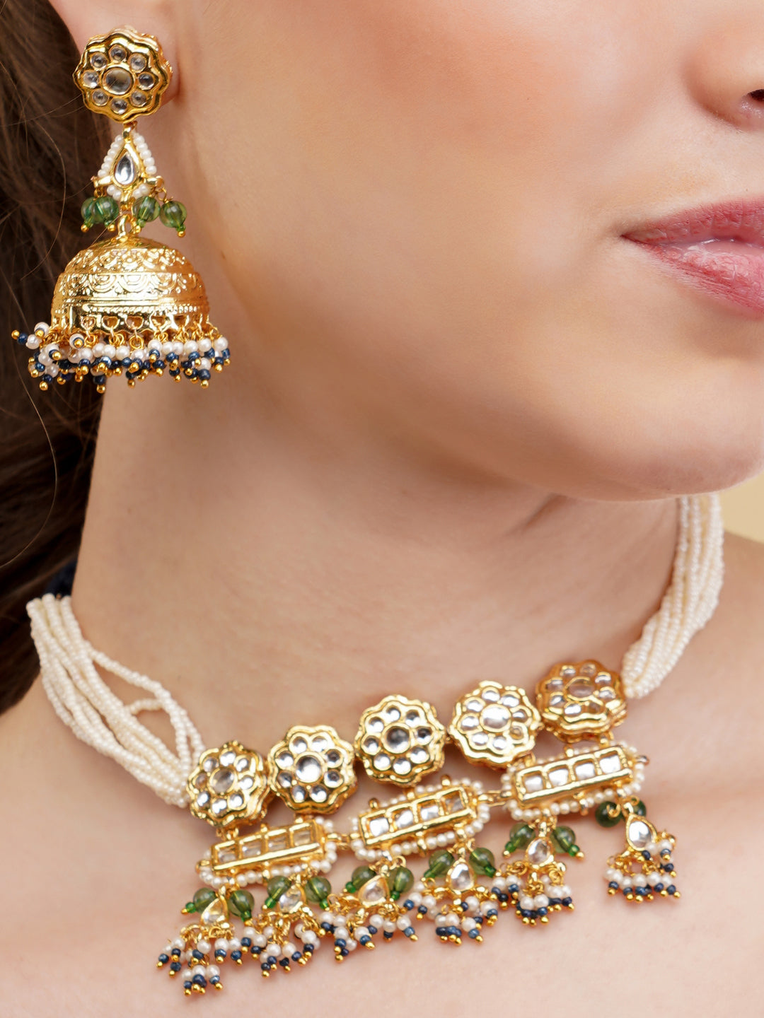 AIVY LUXE traditional Indian jewelry set featuring a gold necklace and matching earrings with pearls and green accents