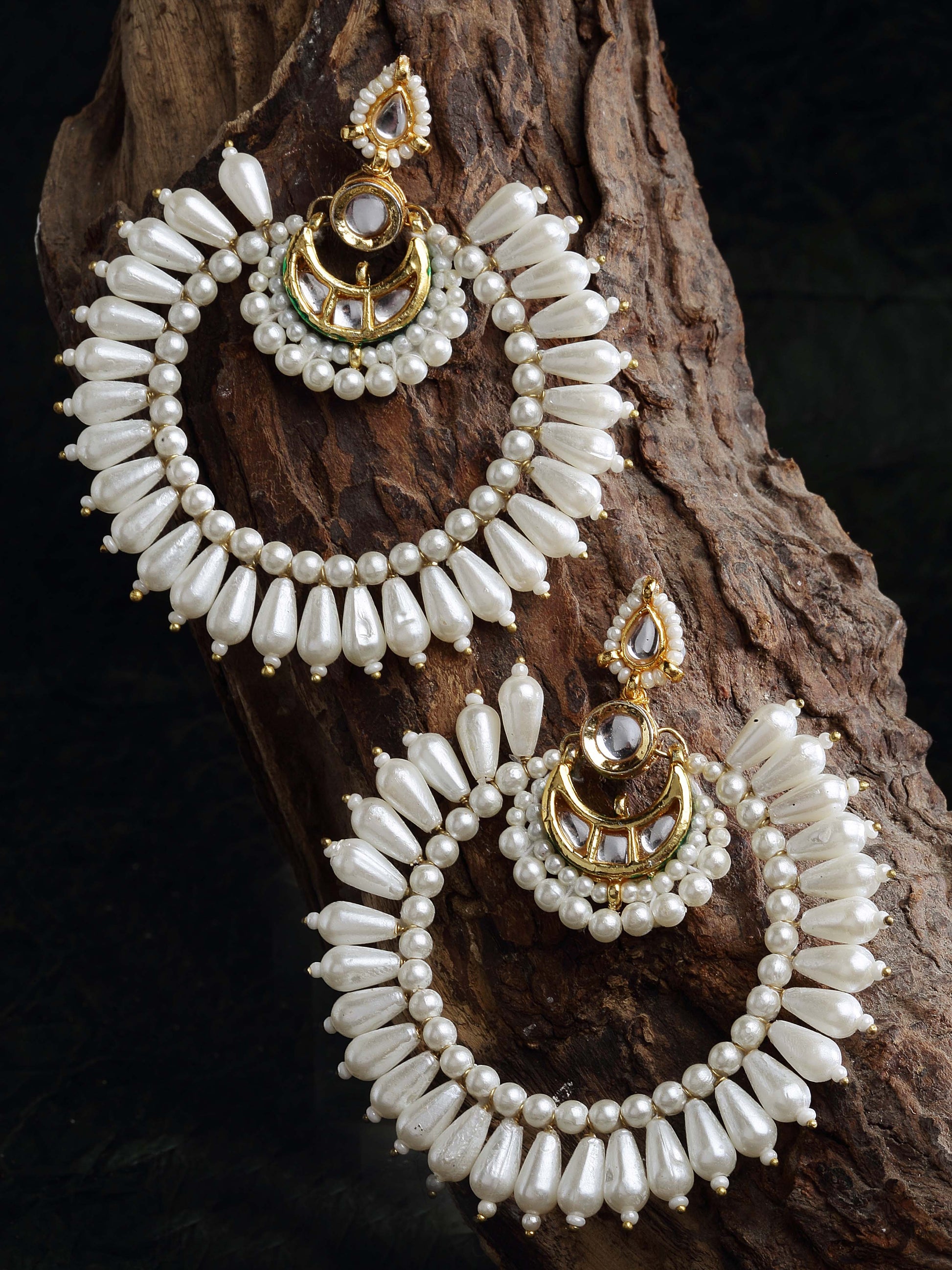 AIVY LUXE Zard Gulab Chand Bala earrings featuring white pearl beads and gold detailing on wooden background