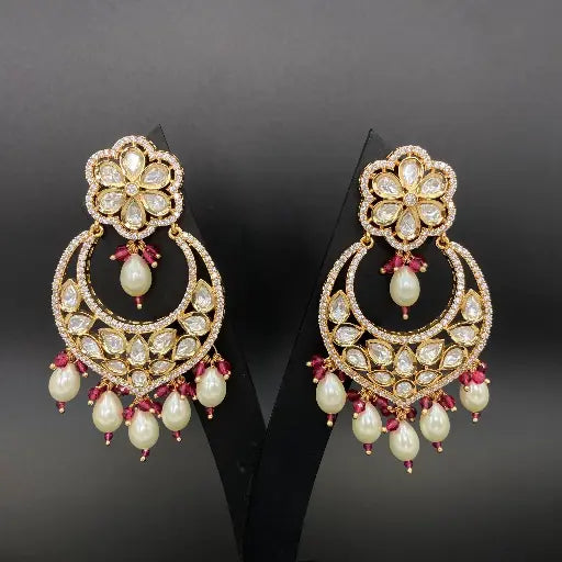 Elegant pair of traditional kundan chandelier earrings with intricate gold-tone setting and pearl drops