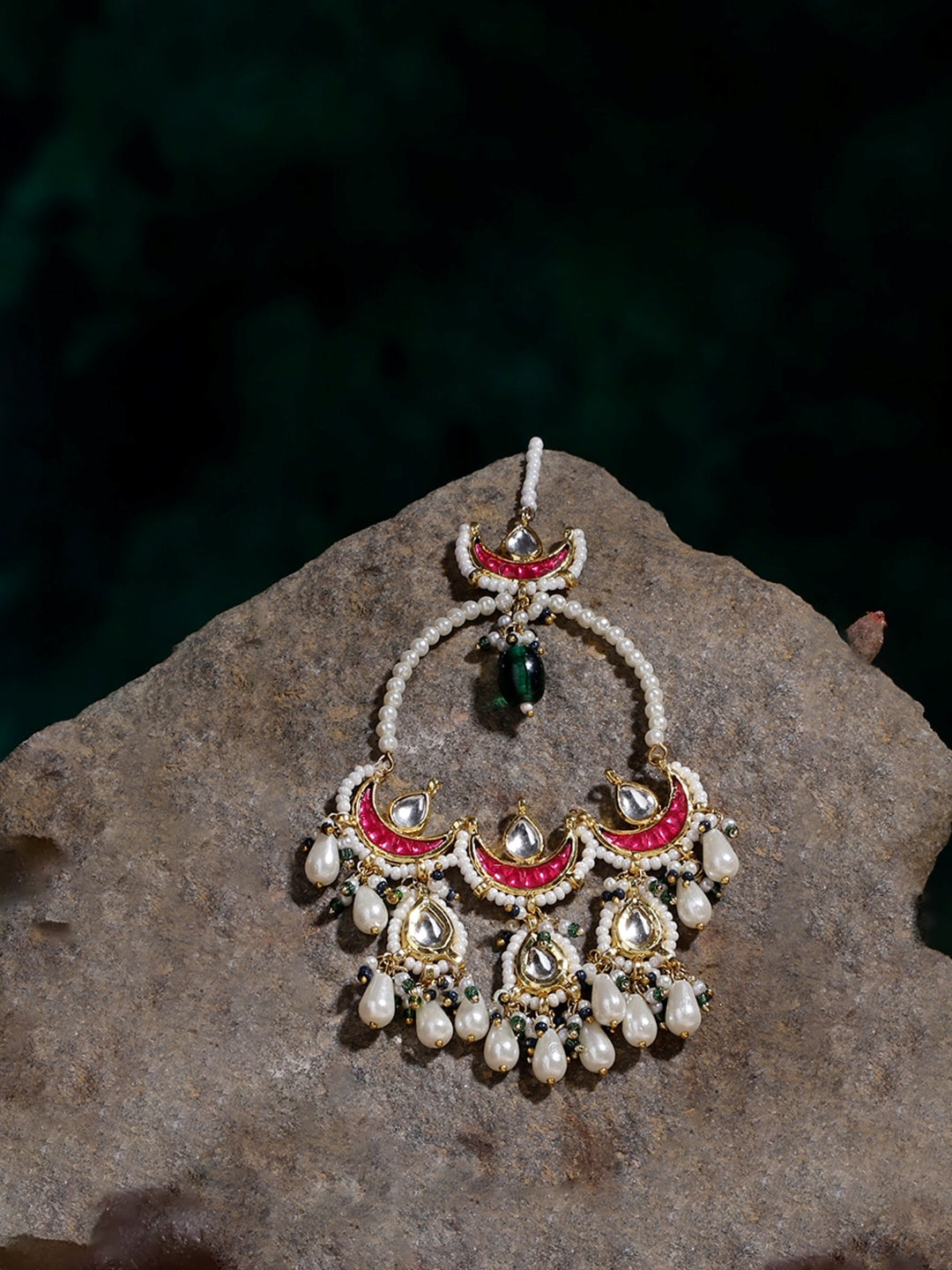 AIVY LUXE Rang-e-Shabnam designer earrings featuring pearl and red stone accents on a textured stone background