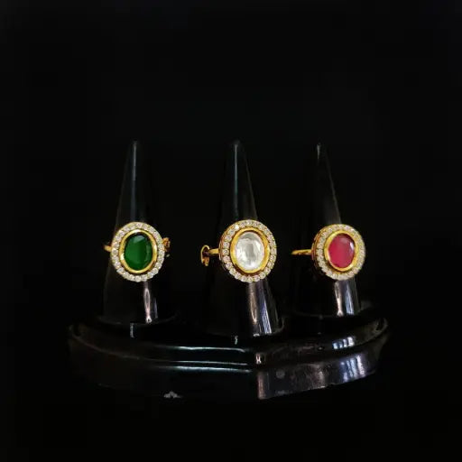 Trio of kundan rings with green, red, and white round stones