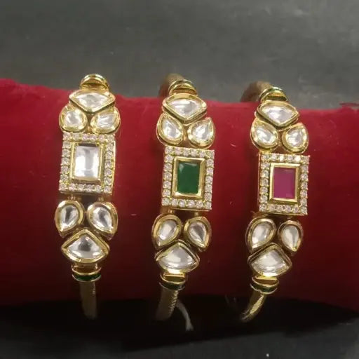 Three gold bangles with rectangular white, green, and pink stones surrounded by kundan petals – fusion-style Indian bangles
