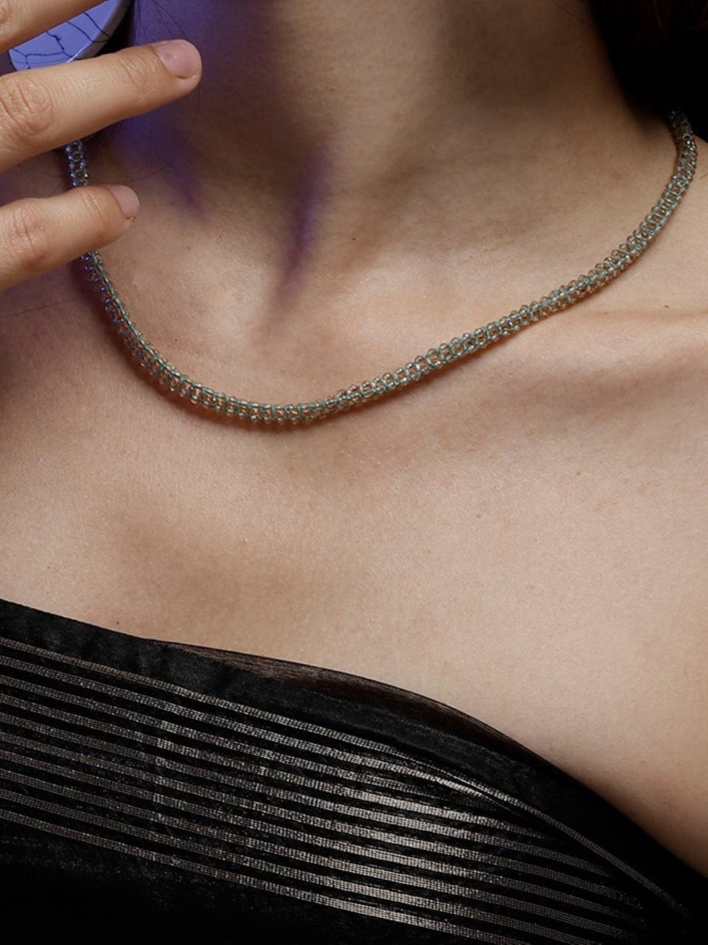 AIVY LUXE artisan statement layered necklace worn on neck with black off shoulder top