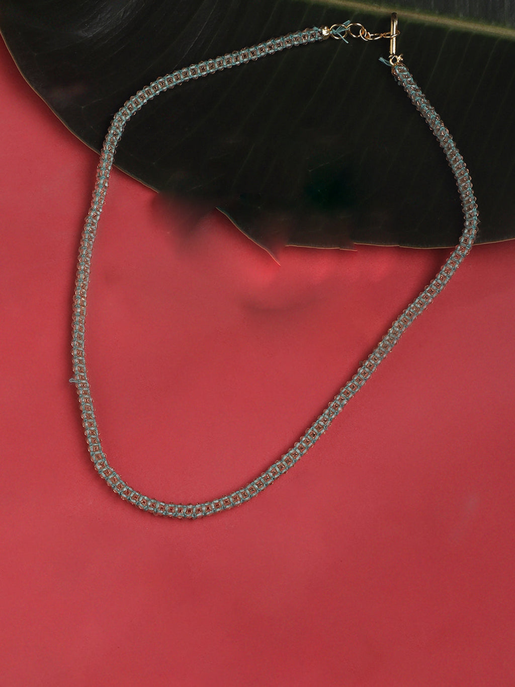 AIVY LUXE artisan statement layered necklace with intricate chain design and toggle clasp on red and black background