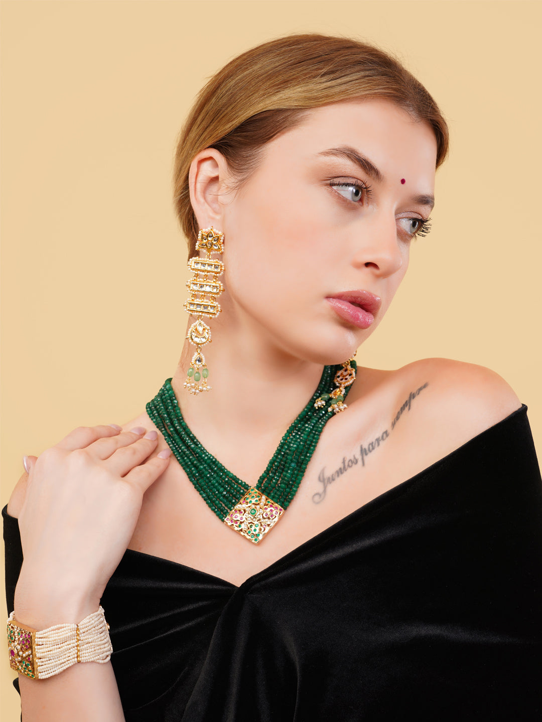 AIVY LUXE beautiful pearl bracelet worn on wrist paired with green beaded necklace and gold earrings