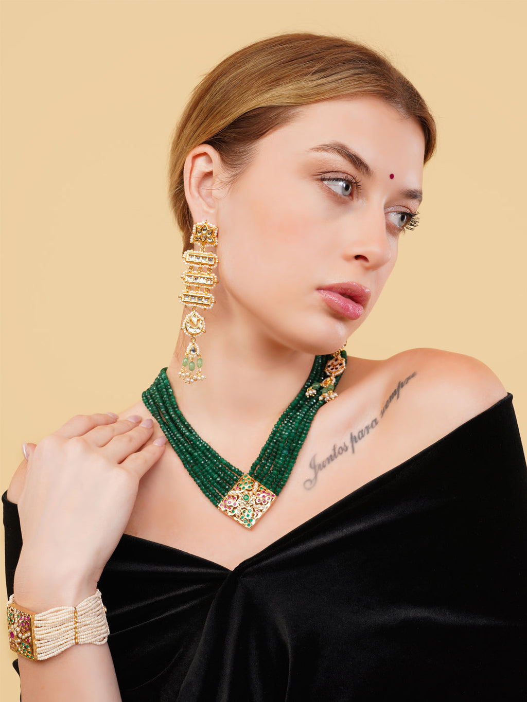 AIVY LUXE beautiful pearl bracelet worn on wrist paired with green beaded necklace and gold earrings