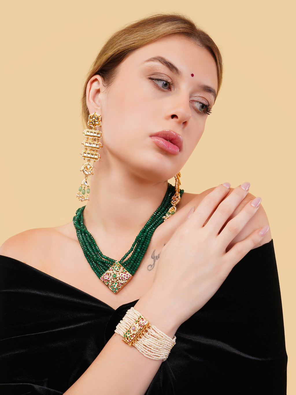 AIVY LUXE beautiful pearl bracelet worn on wrist with layered green necklace and gold earrings