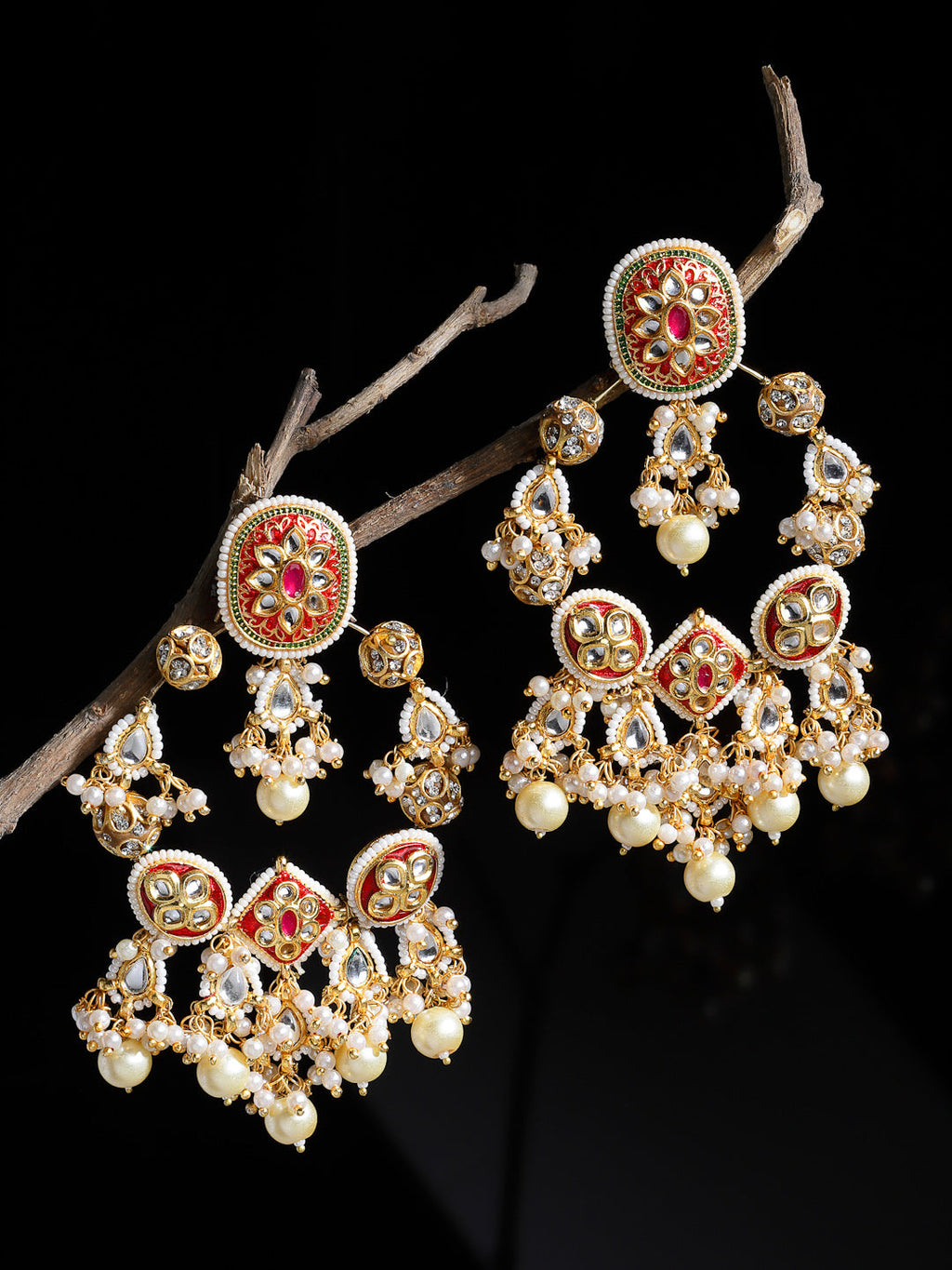 AIVY LUXE designer pearl drop earrings with intricate gold and red detailing hanging on a branch