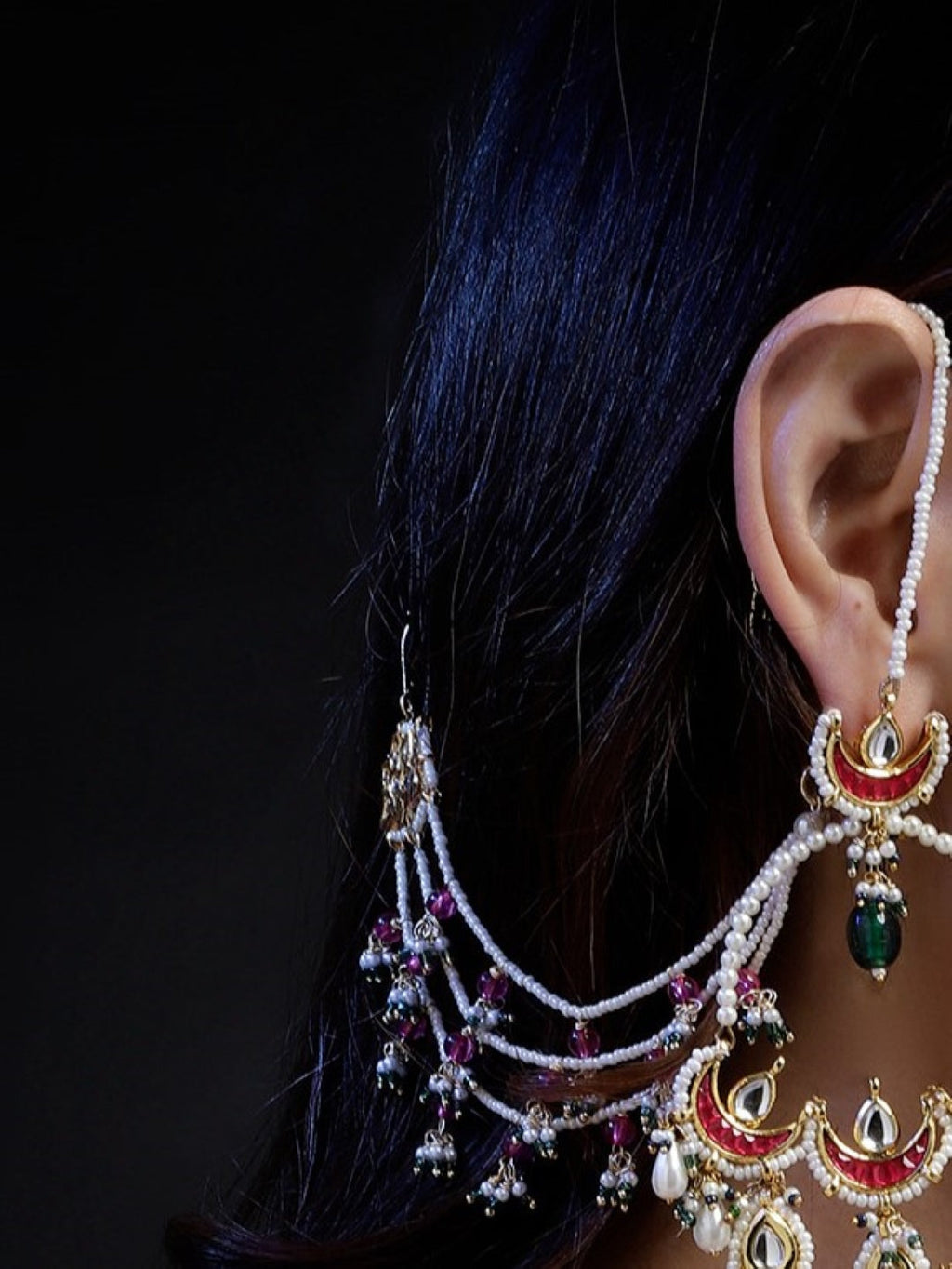 AIVY LUXE ethnic statement ear chains featuring white beads and intricate red and green adornments on the ear