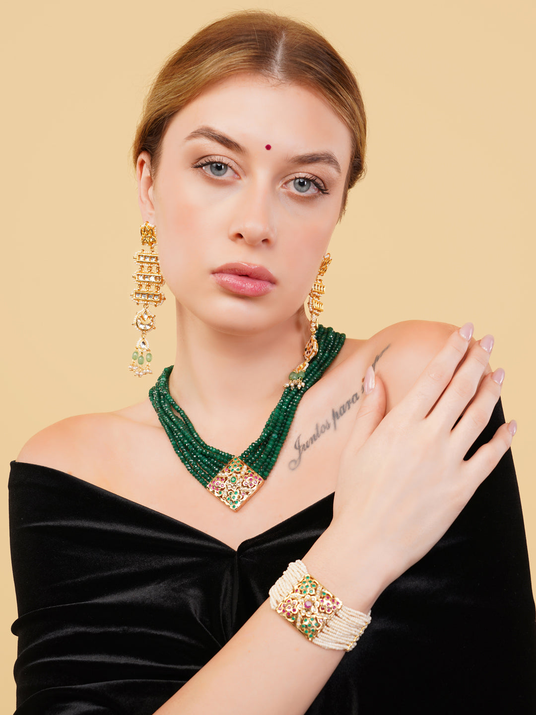 AIVY LUXE green beaded necklace with gold pendant worn with statement earrings and bracelet