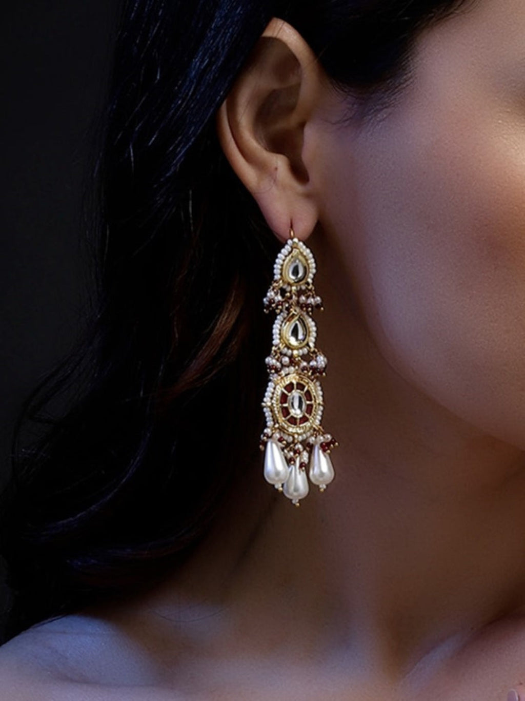 AIVY LUXE fusion jewelry earrings with intricate gold detailing and pearl drops worn on the ear