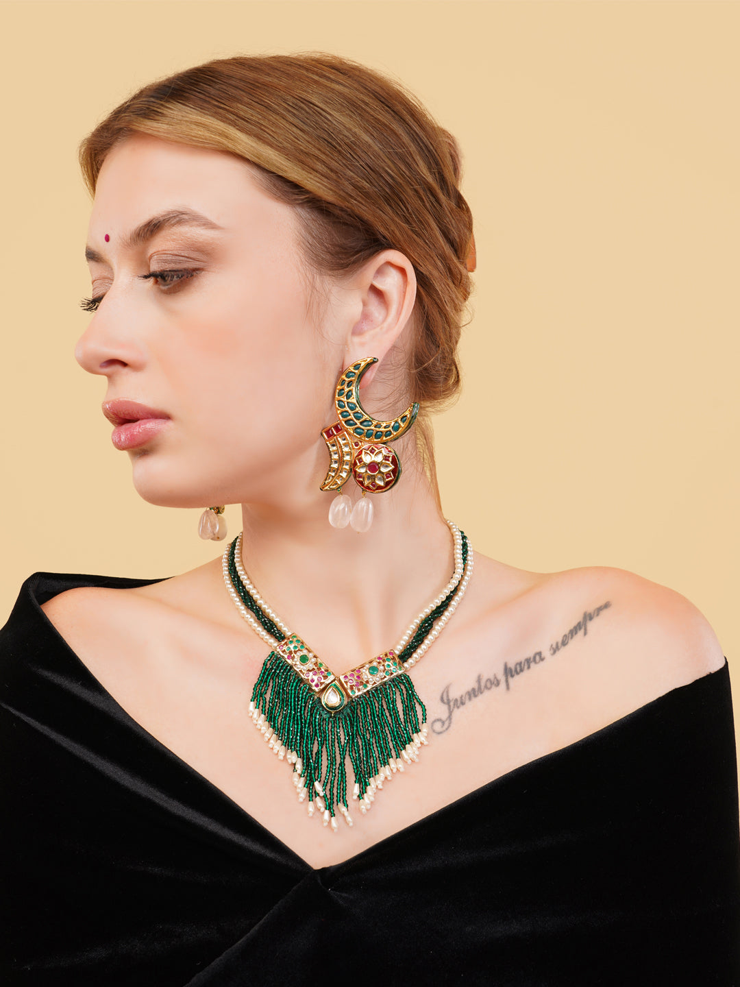 AIVY LUXE green beaded fringe necklace worn by woman with black off shoulder top and statement earrings