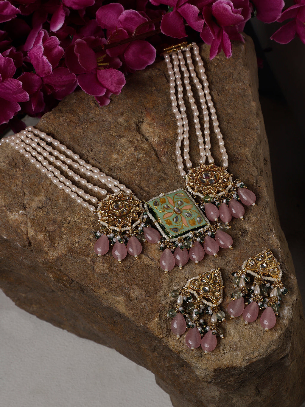 AIVY LUXE Gulshan Sitara statement earrings with pearl strands and pink bead accents on a stone surface