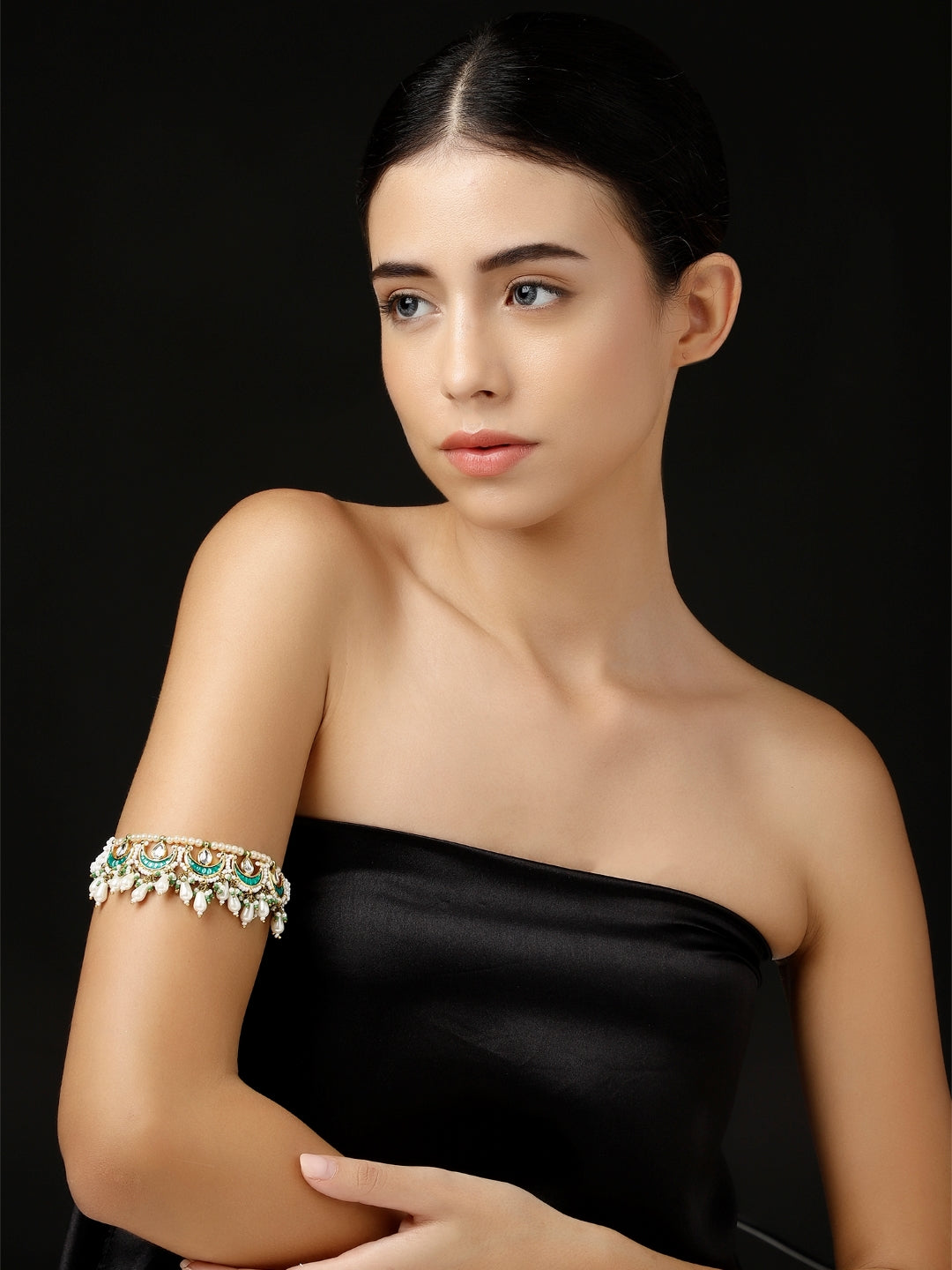 AIVY LUXE handcrafted bajuband bracelet worn on upper arm with intricate design and green accents