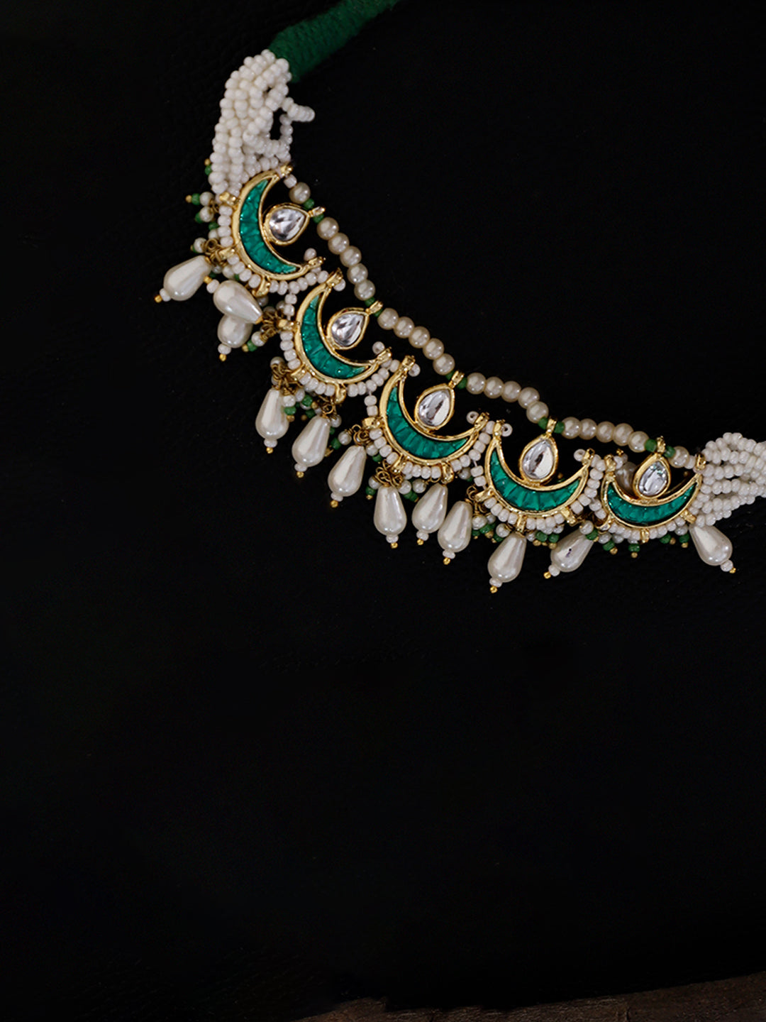 AIVY LUXE handcrafted bajuband bracelet with green enamel, white beads, and pearl accents on black background