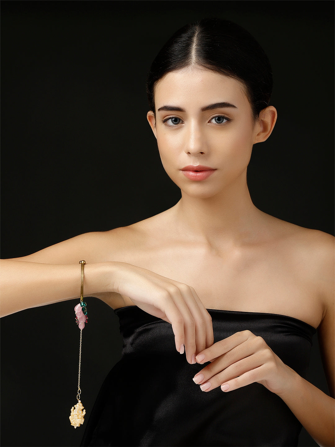 AIVY LUXE handcrafted bracelet for women with delicate charms worn by woman in black dress