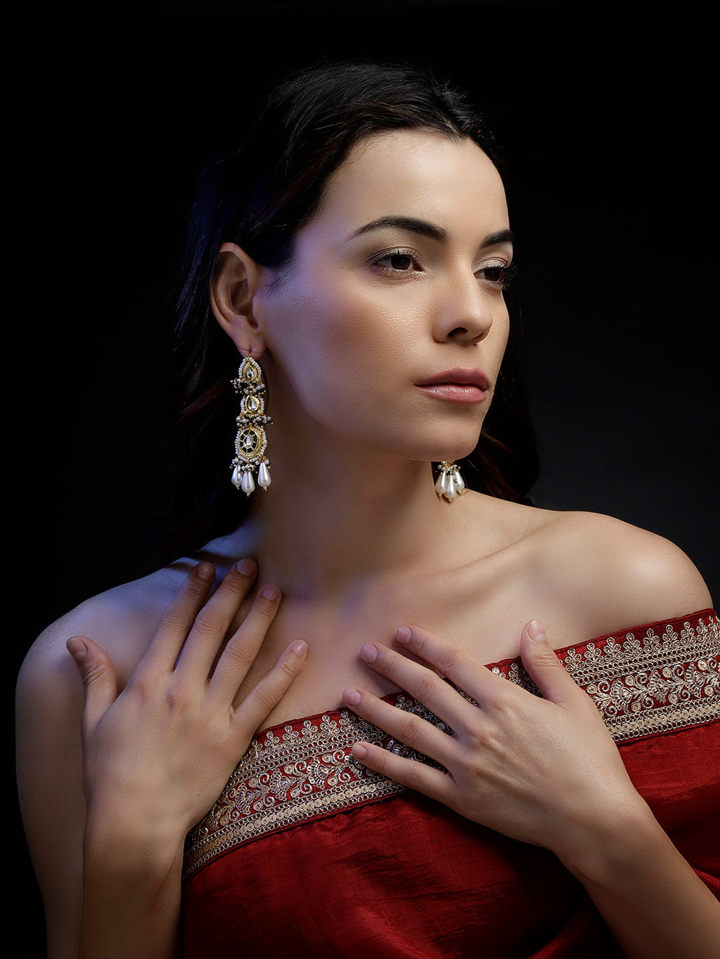 AIVY LUXE handcrafted drop earrings worn by woman in red off-shoulder dress against black background
