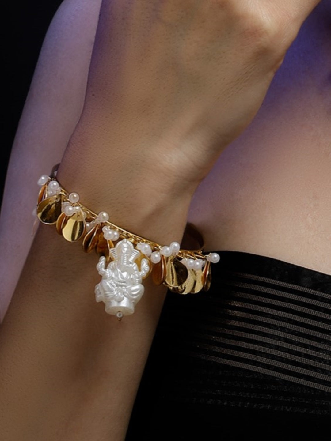 AIVY LUXE handcrafted fusion bracelets featuring gold charms and a central white figurine with pearl accents on wrist