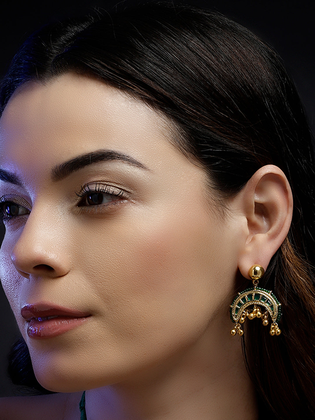 AIVY LUXE handcrafted statement earrings worn by woman featuring gold and green intricate design