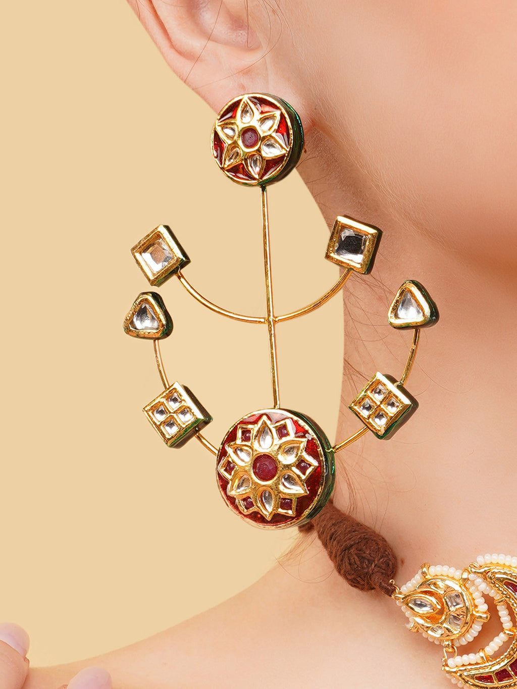 AIVY LUXE heritage style drop earrings with intricate gold design and red gemstone details worn on ear