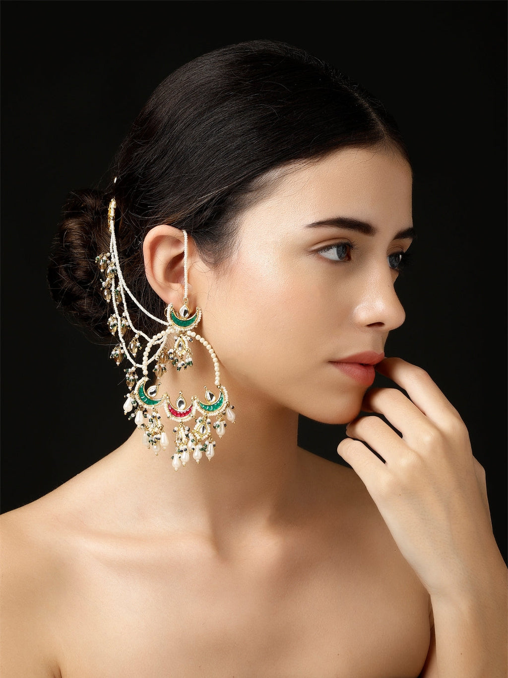 AIVY LUXE Husn-e-Arq Kanchain earrings in gold with green and red accents worn by a woman
