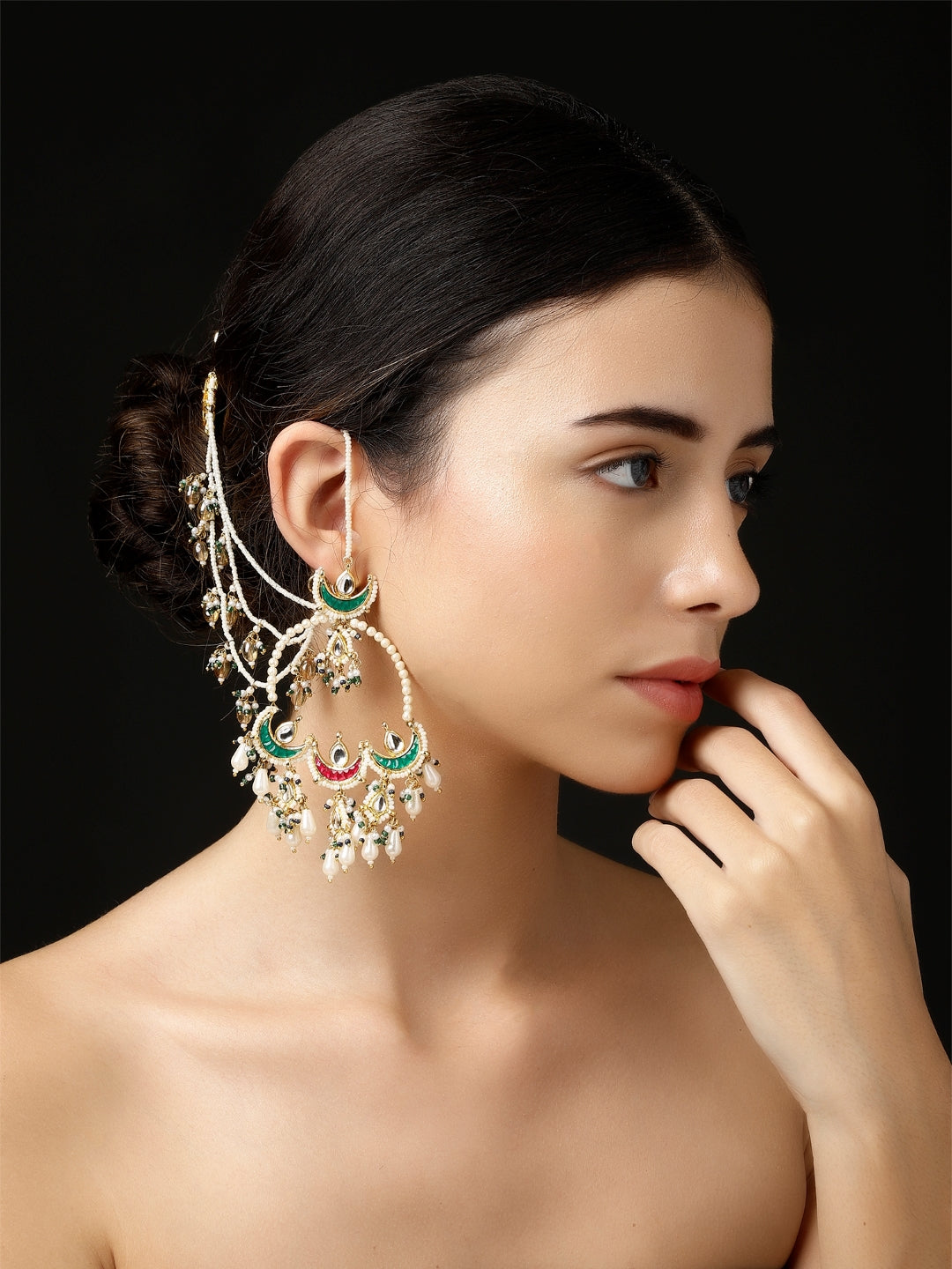 A model wearing AIVY LUXE Husn-e-Arq Kanchain earrings with intricate green and gold design and pearl accents