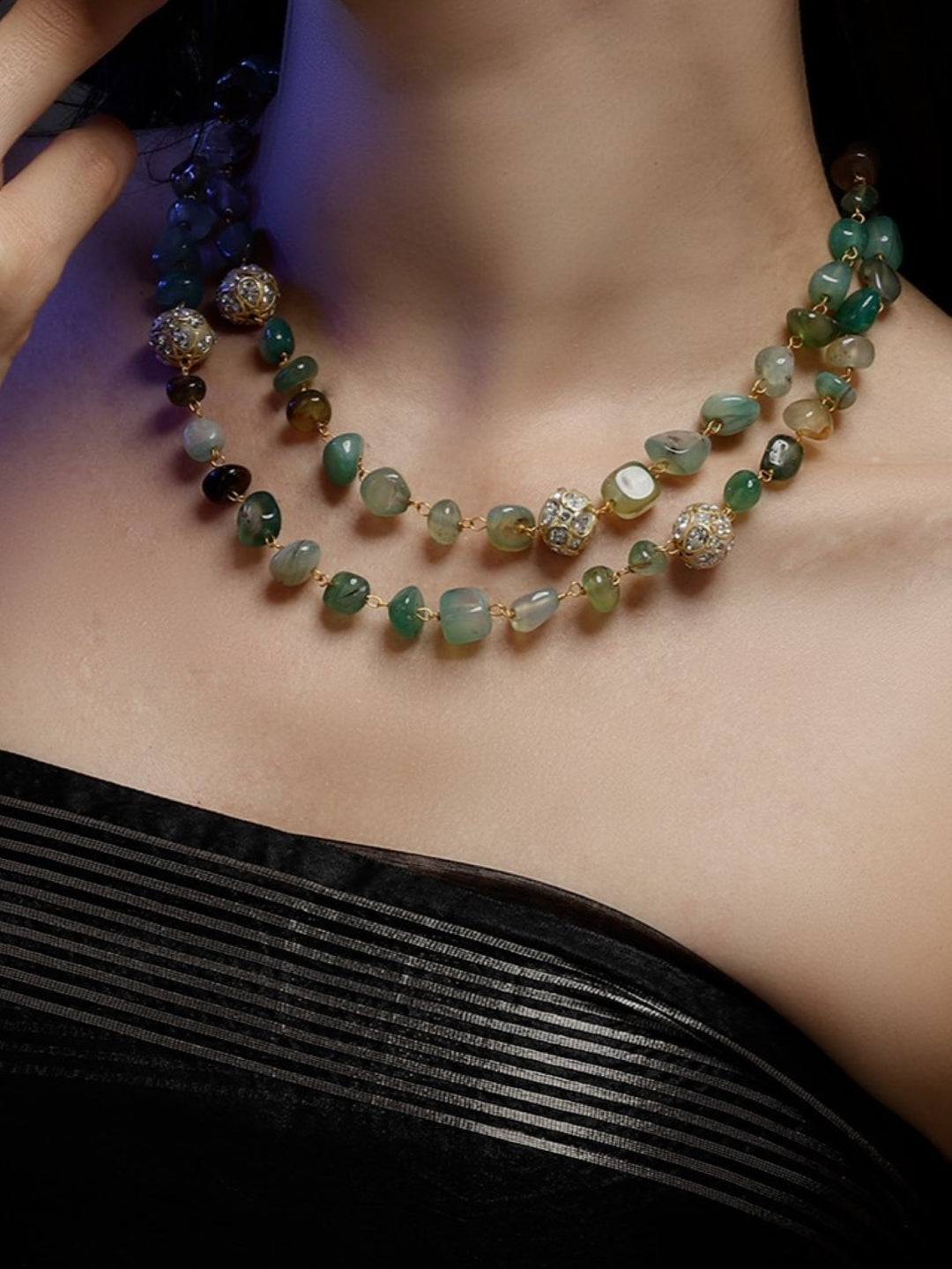 AIVY LUXE layered green gemstone necklace featuring multi-colored beads and gold accents on a woman's neck