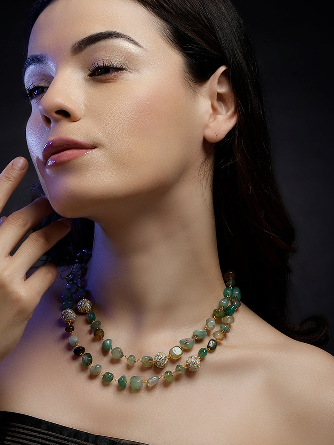 AIVY LUXE layered green gemstone necklace worn by a woman with dark hair and glowing skin
