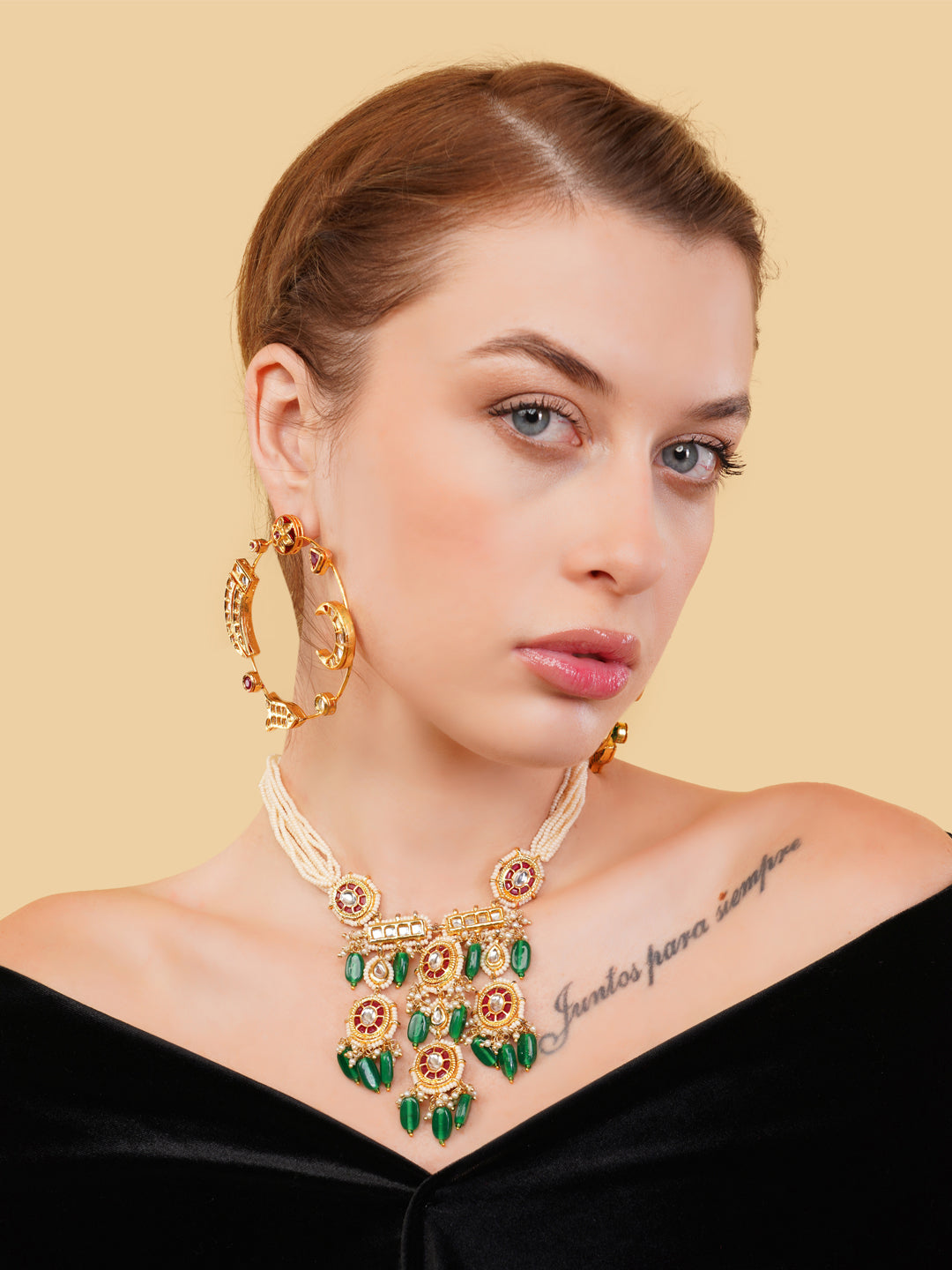 AIVY LUXE luxury ethnic gemstone necklace with green and gold accents worn by a woman