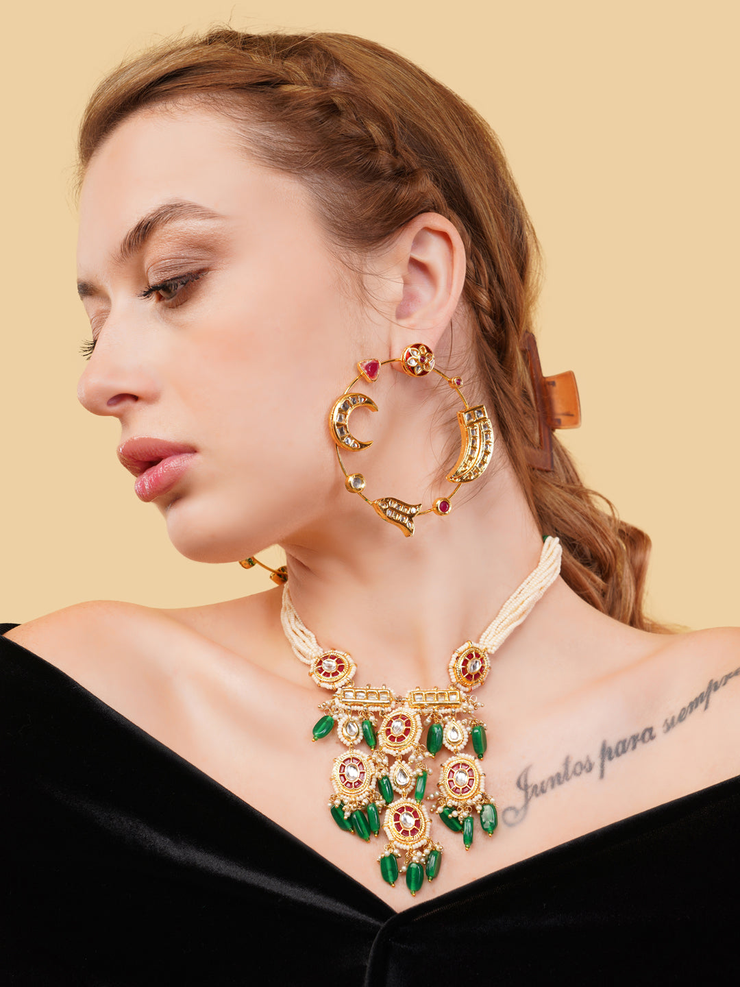 AIVY LUXE luxury ethnic gemstone necklace with green stones and intricate gold design worn by a woman