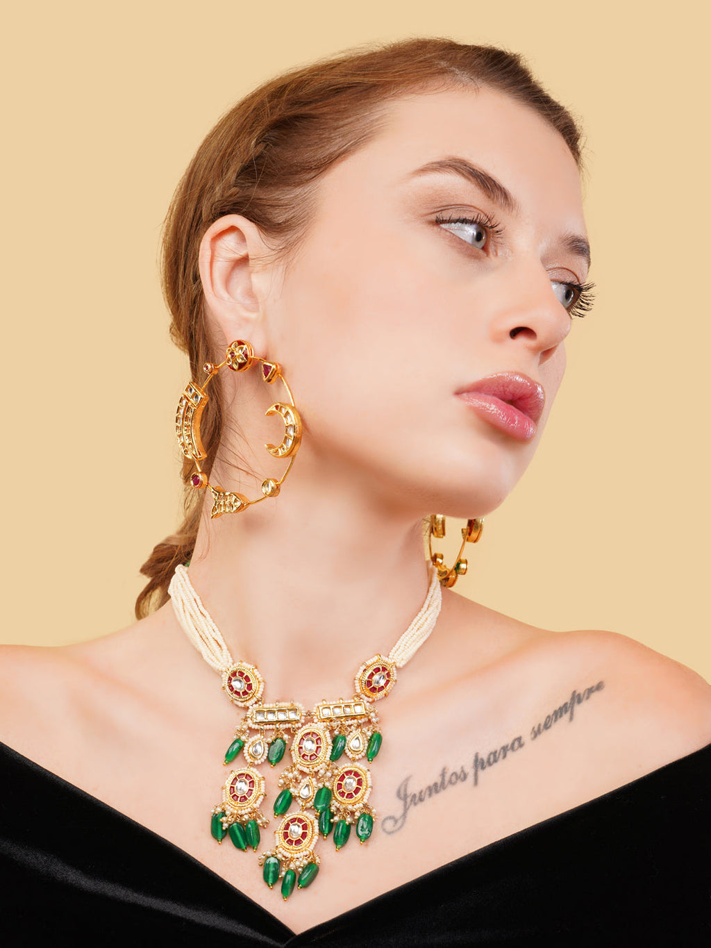 AIVY LUXE luxury ethnic gemstone necklace with green stones worn by model with matching earrings
