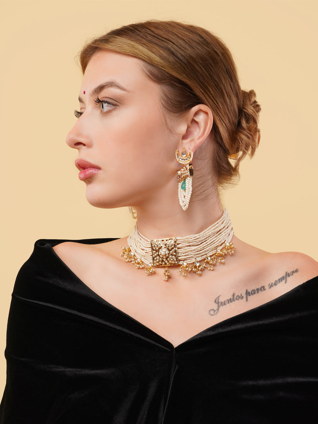AIVY LUXE pearl choker with gold detailing worn by a woman with statement earrings and black off-shoulder dress