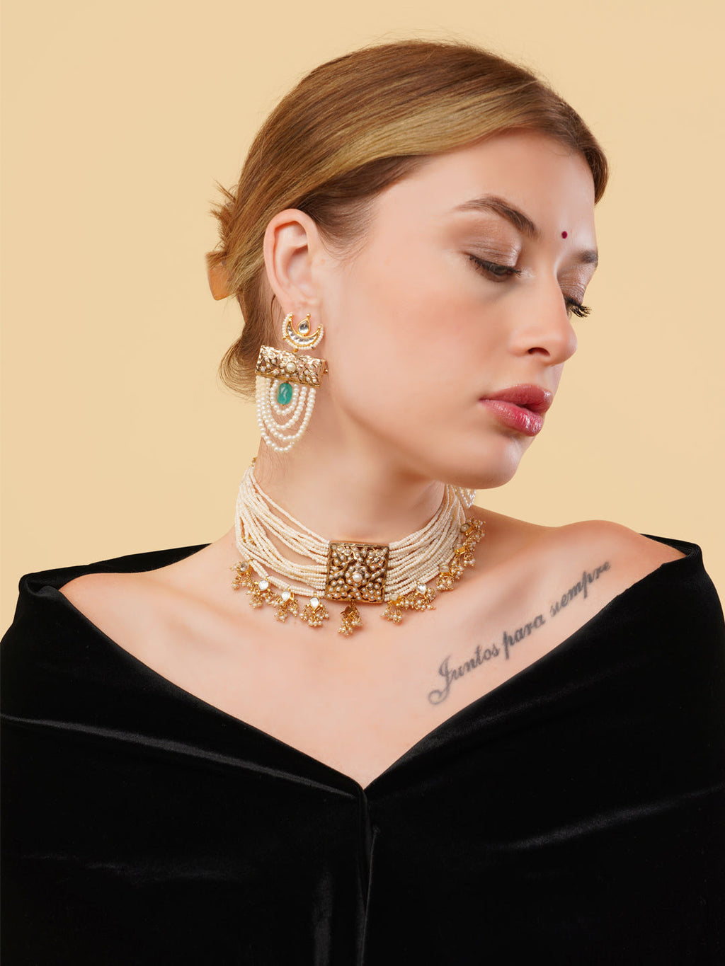 AIVY LUXE pearl choker with gold detailing worn by a woman with matching earrings and black off-shoulder outfit