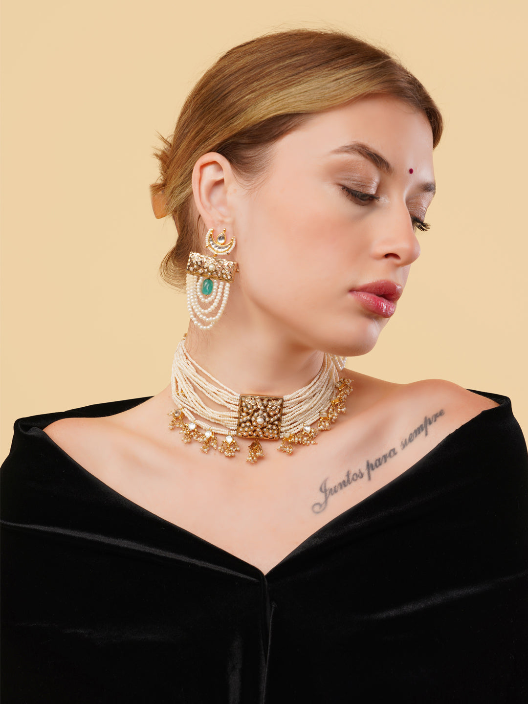 Pearl choker with gold detailing worn by woman paired with matching earrings from AIVY LUXE