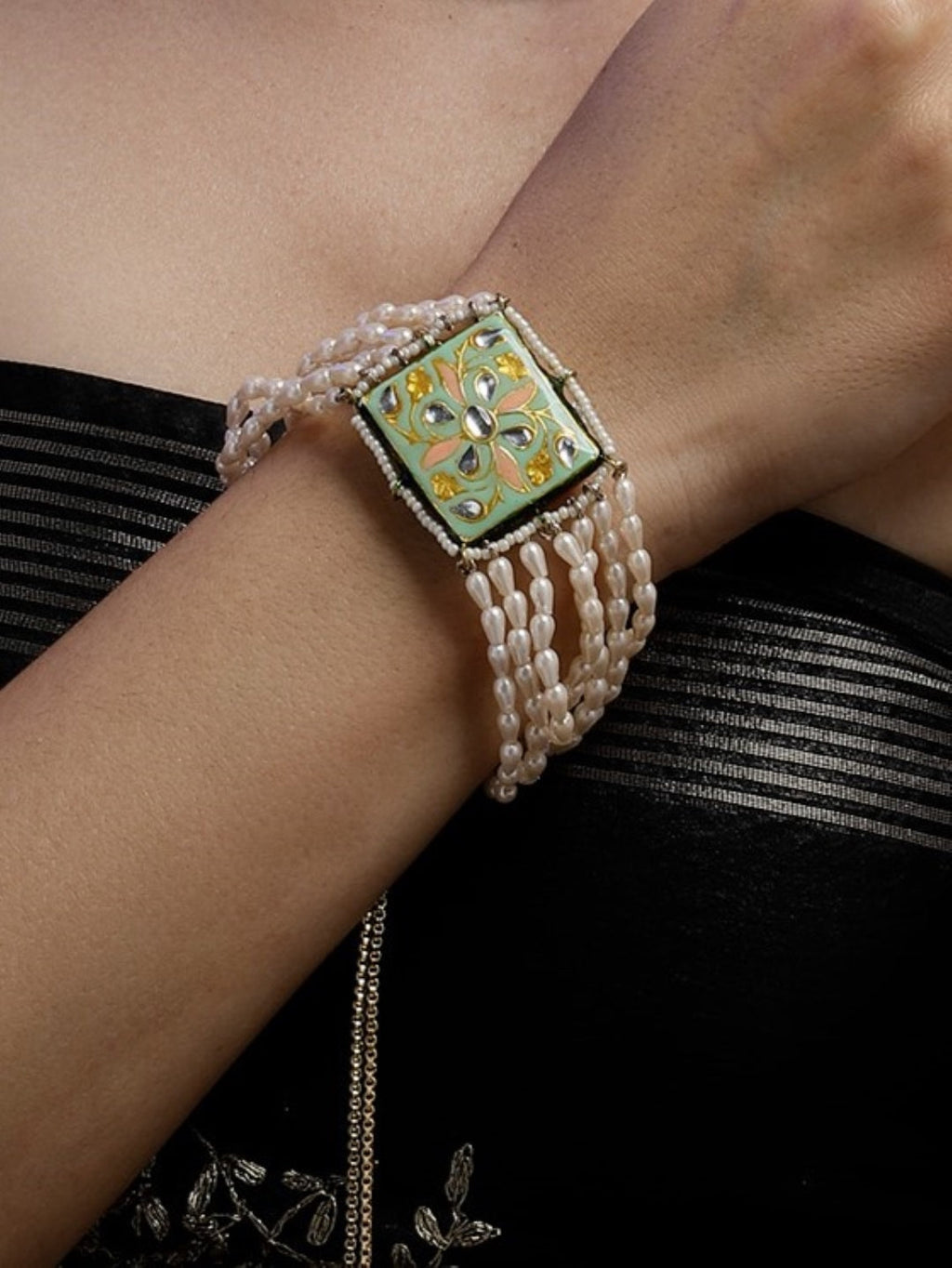 AIVY LUXE premium designer pearl bracelet with intricate green and gold centerpiece on wrist